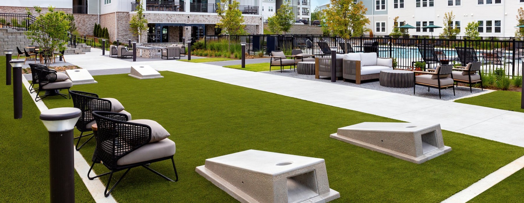 a cornhole area with chairs