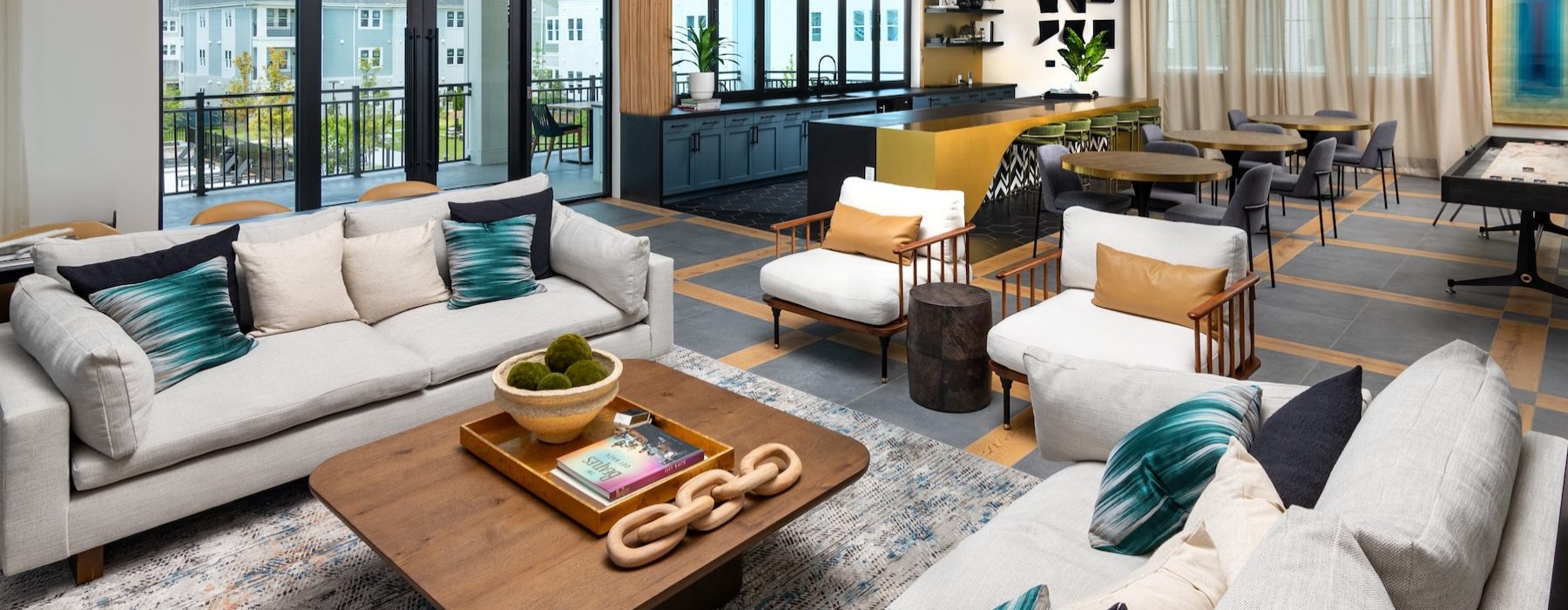 a clubroom with couches, tables and chairs