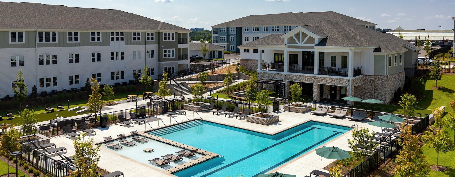 a swimming pool in front of a large building