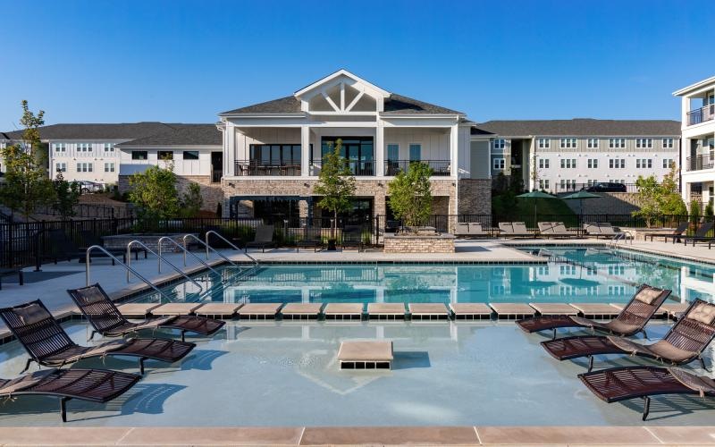 a swimming pool in front of a large building