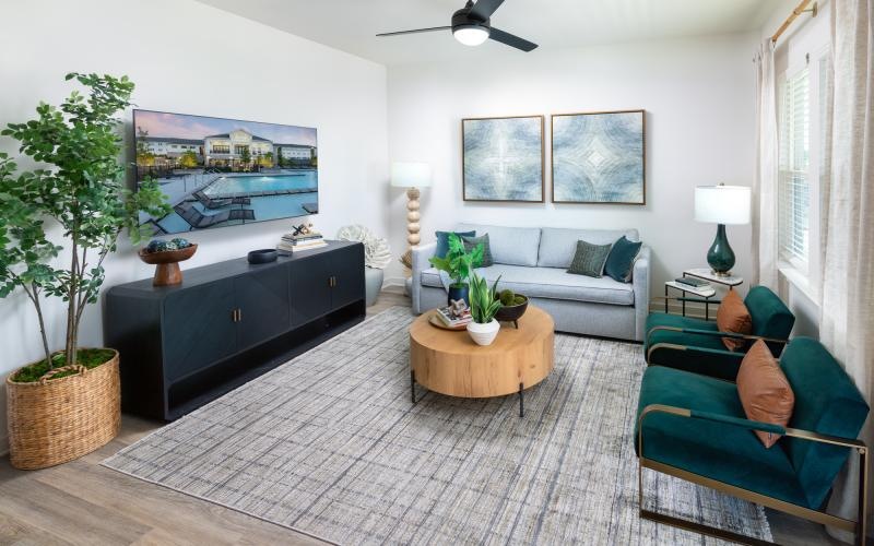 a living room with couches and a dresser